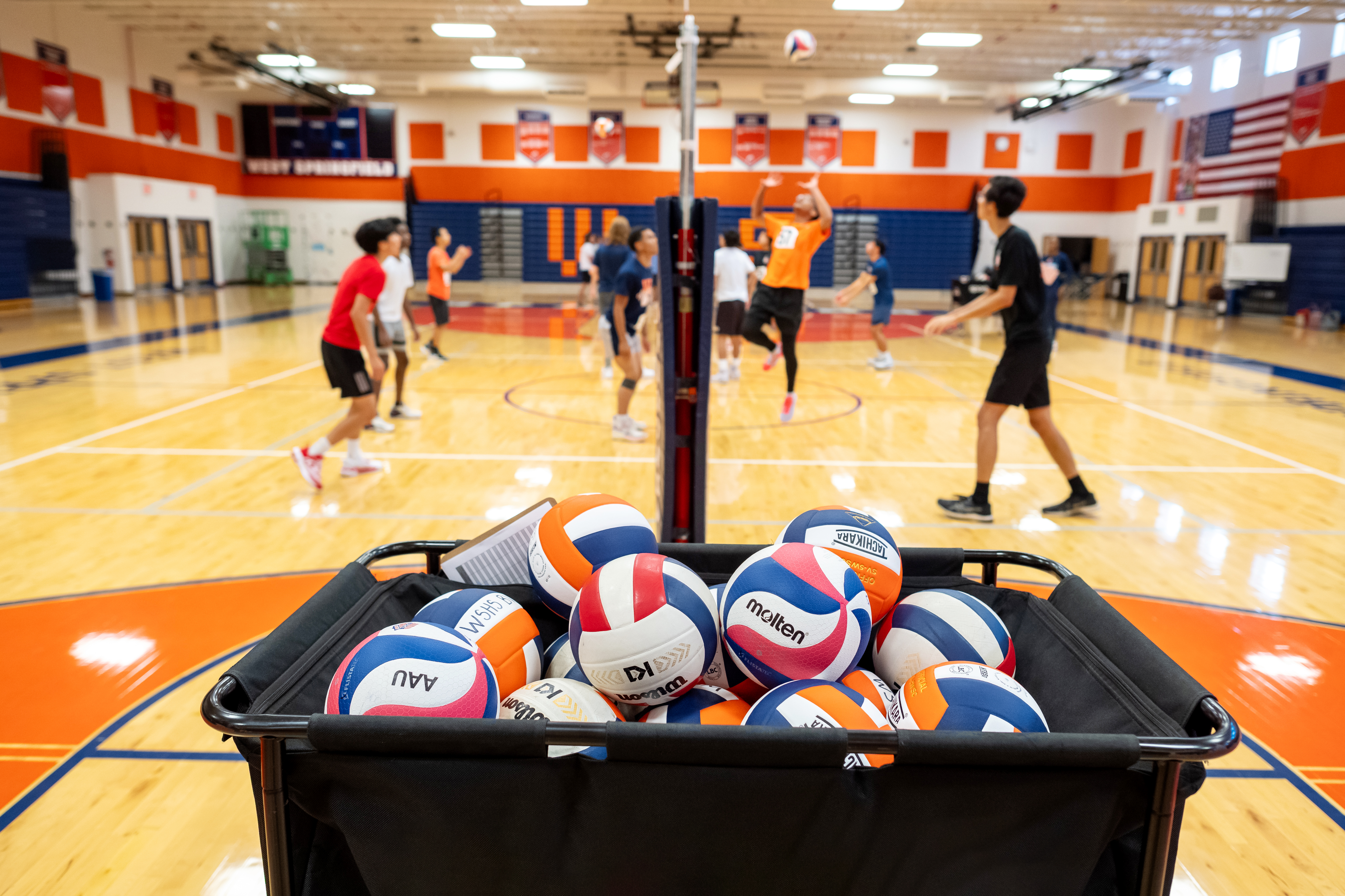 Students on both sides of the net practice their skills.