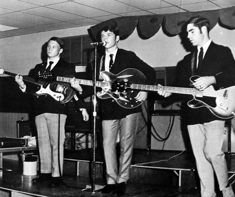 Black and white photograph of three West Springfield High School students performing in a band at the school Sadie Hawkins dance.