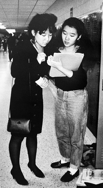 Black and white photograph of two female students standing in a hallway at West Springfield High School.