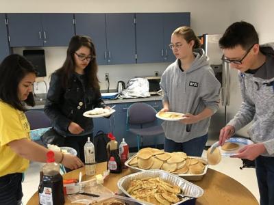 students getting their pancakes for breakfast